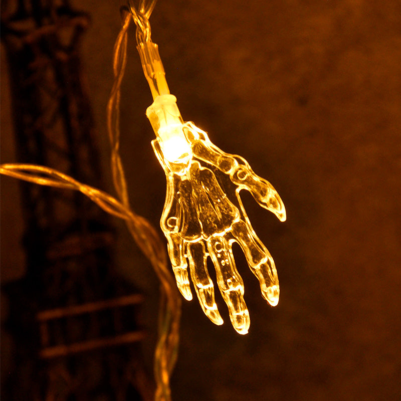 Multiple skeleton hand LED lights glowing amber yellow spread on dark surface