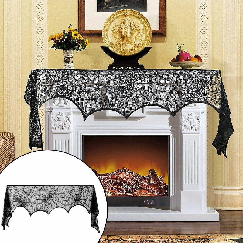 Black lace spiderweb scarf draped over white fireplace mantle with lit fire